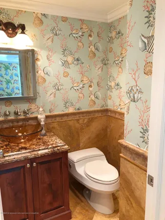 a white toilet sitting next to a shower curtain
