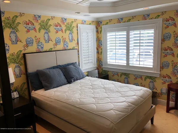 a bedroom with a bed and a window with painted walls