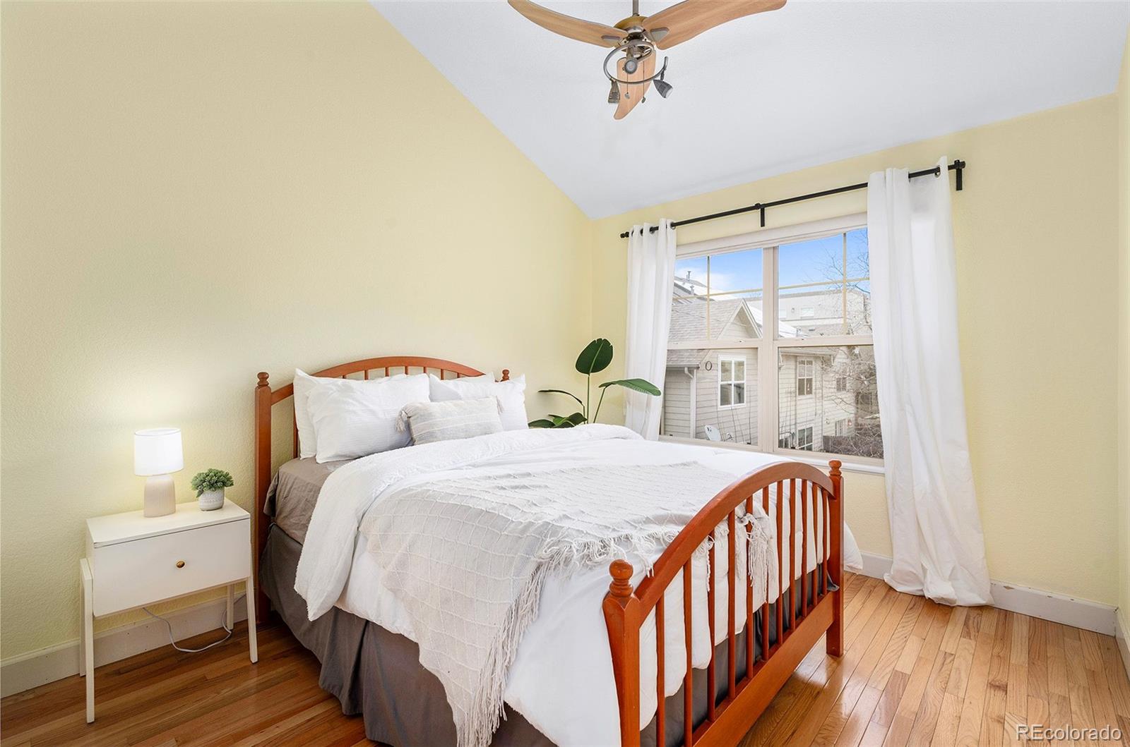 84 Inca Street Denver, CO 80223 - Photo 25 of 32 a bedroom with a bed and wooden floor