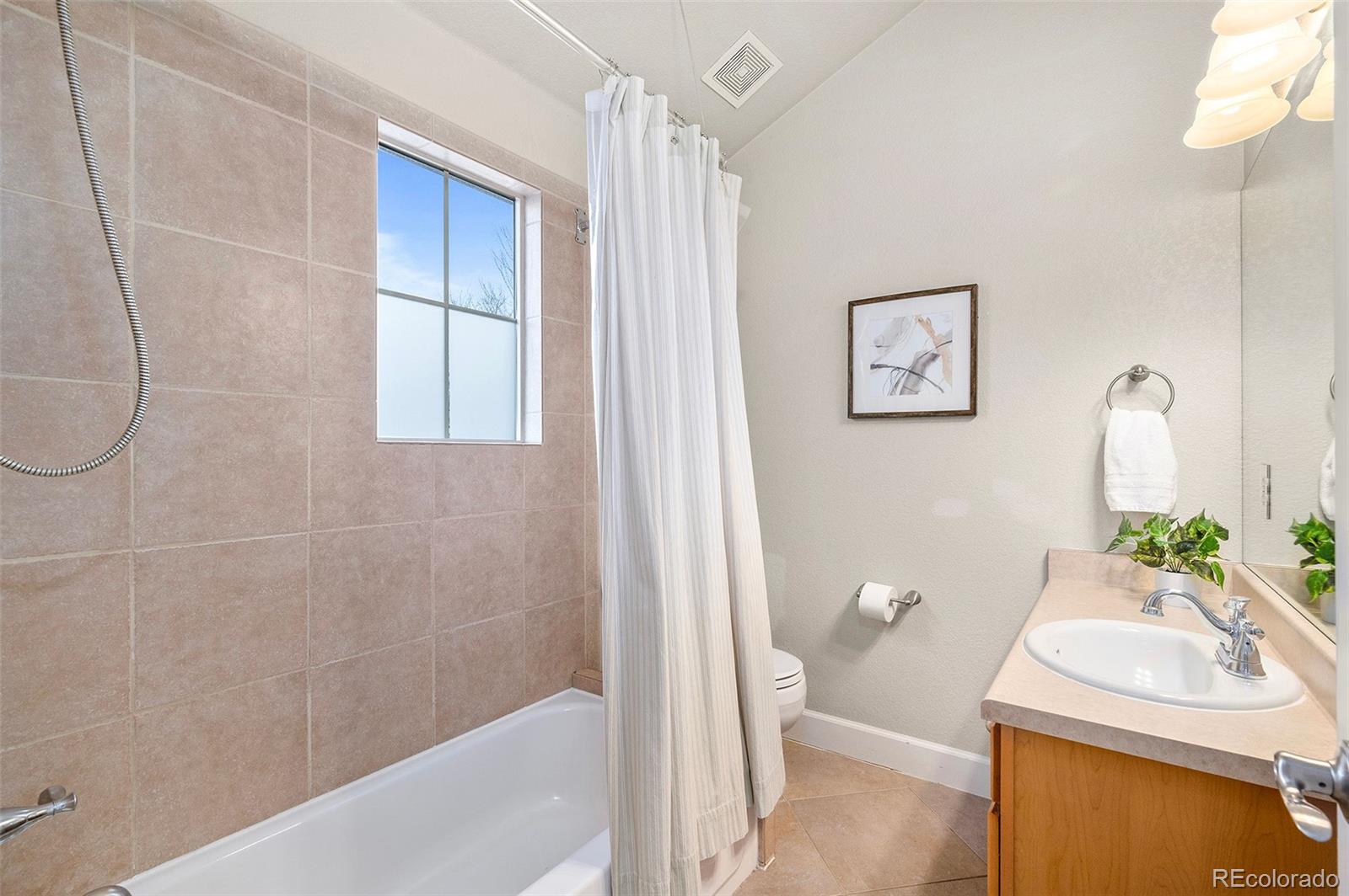 84 Inca Street Denver, CO 80223 - Photo 26 of 32 a bathroom with a sink a toilet and shower
