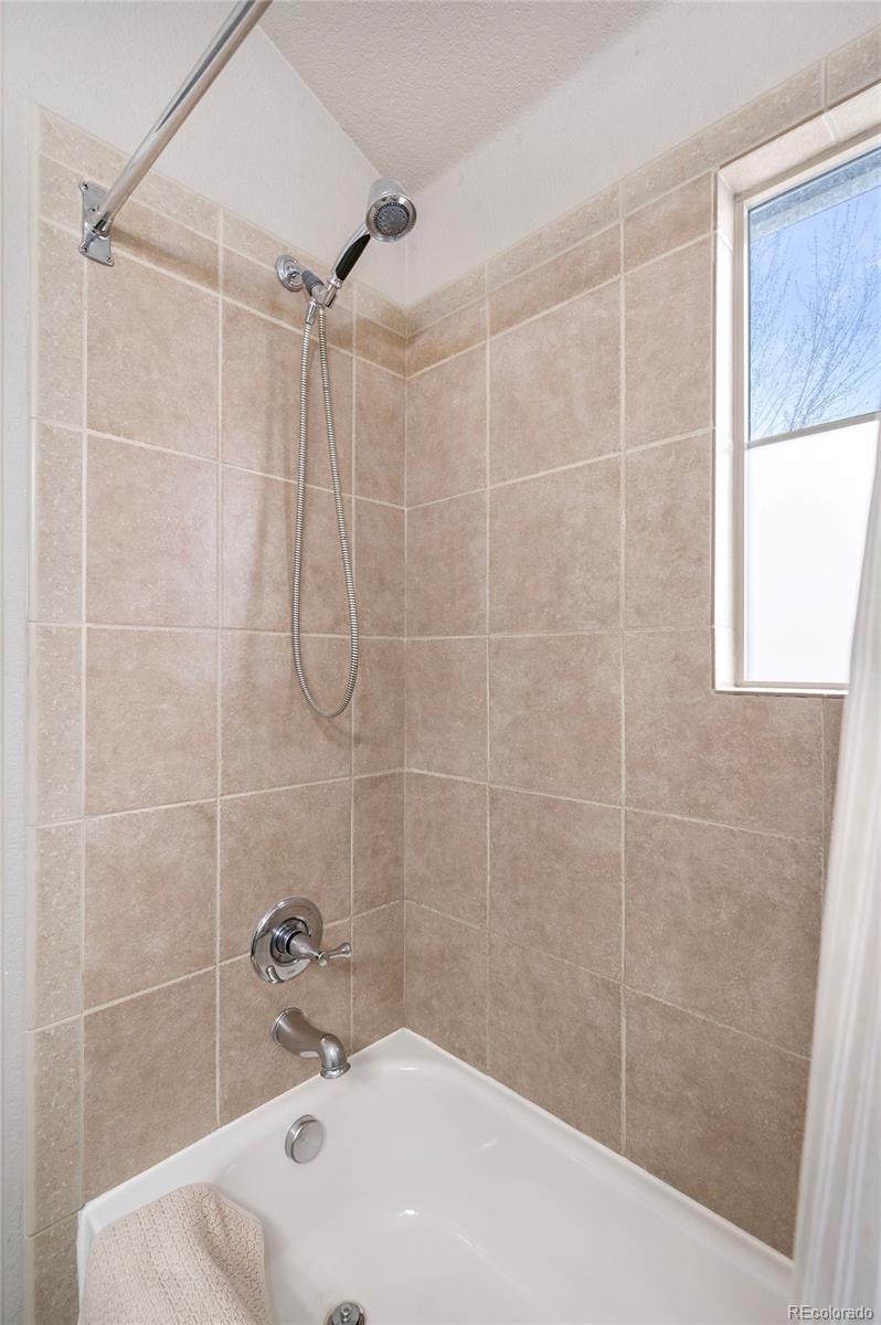 84 Inca Street Denver, CO 80223 - Photo 27 of 32 a bathroom with a shower and a sink