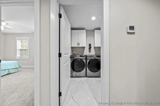 a utility room with sink dryer and washer