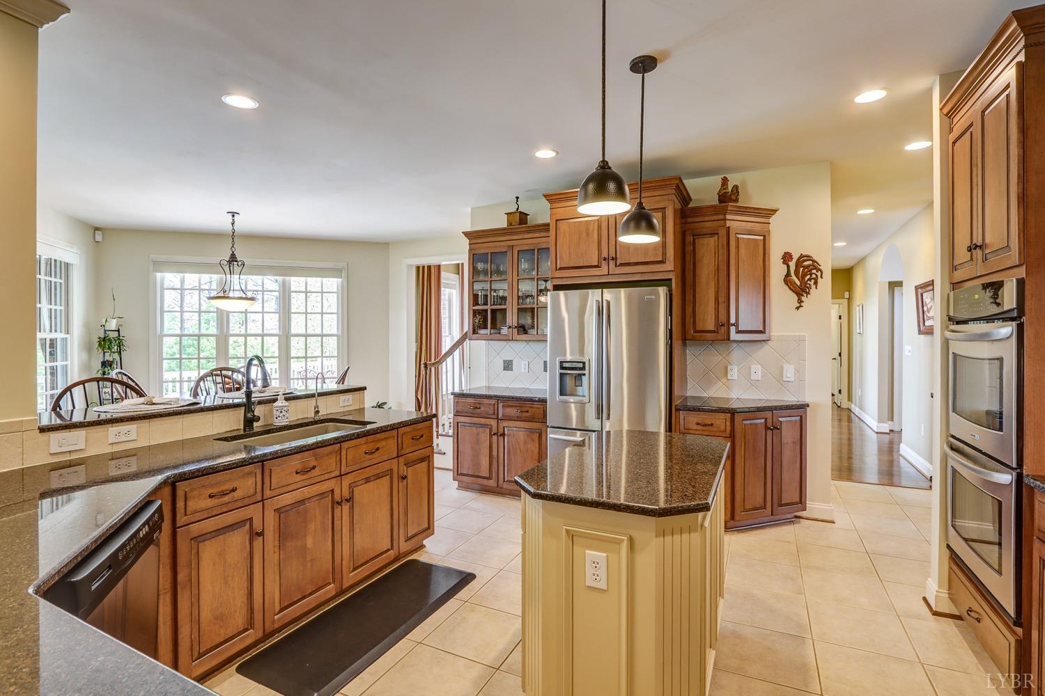 107 Emory Way Amherst, VA 24521 - Photo 21 of 85 a kitchen with stainless steel appliances kitchen island granite countertop a refrigerator and cabinets