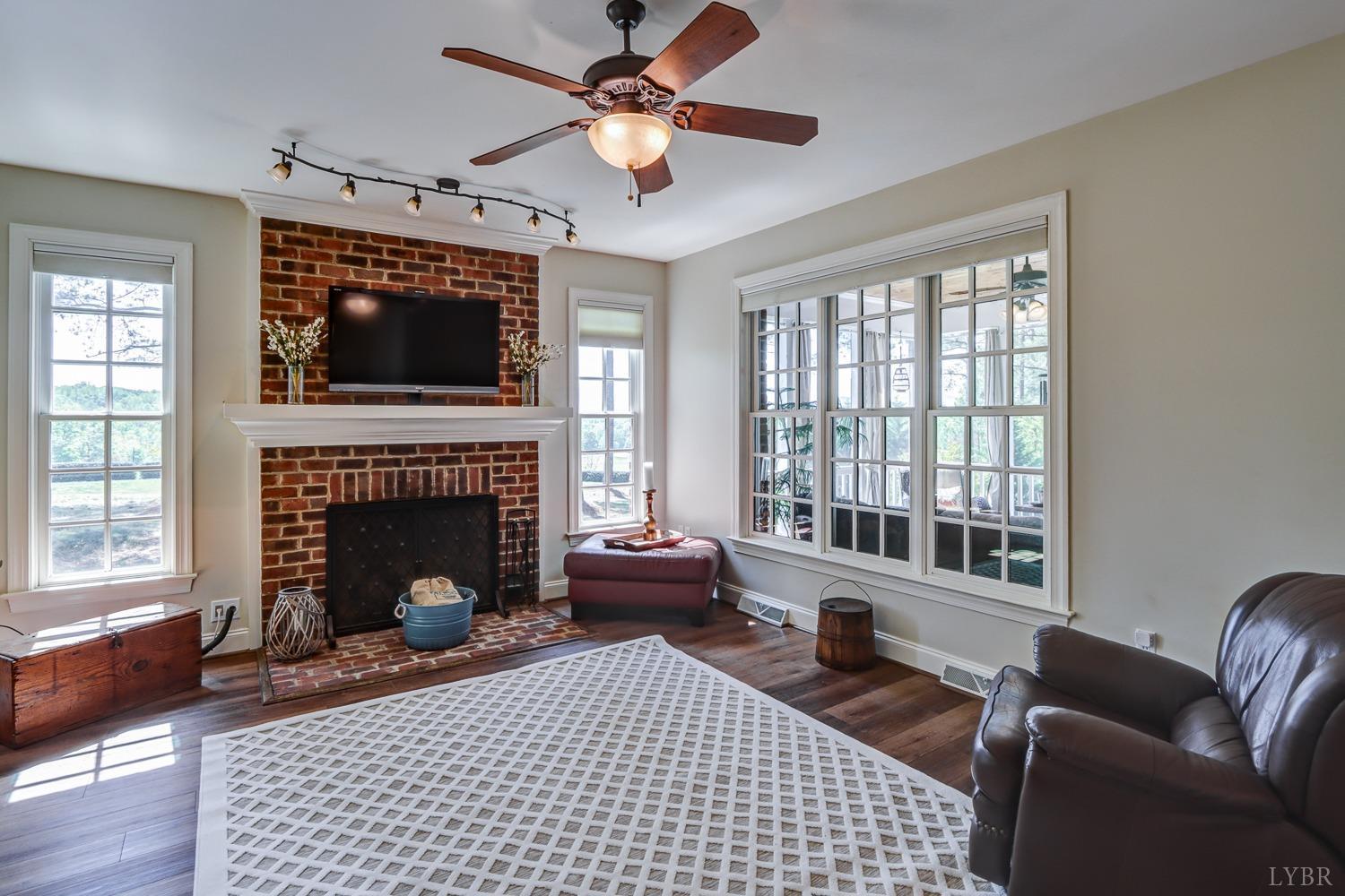 107 Emory Way Amherst, VA 24521 - Photo 30 of 85 a living room with furniture a flat screen tv and a fireplace