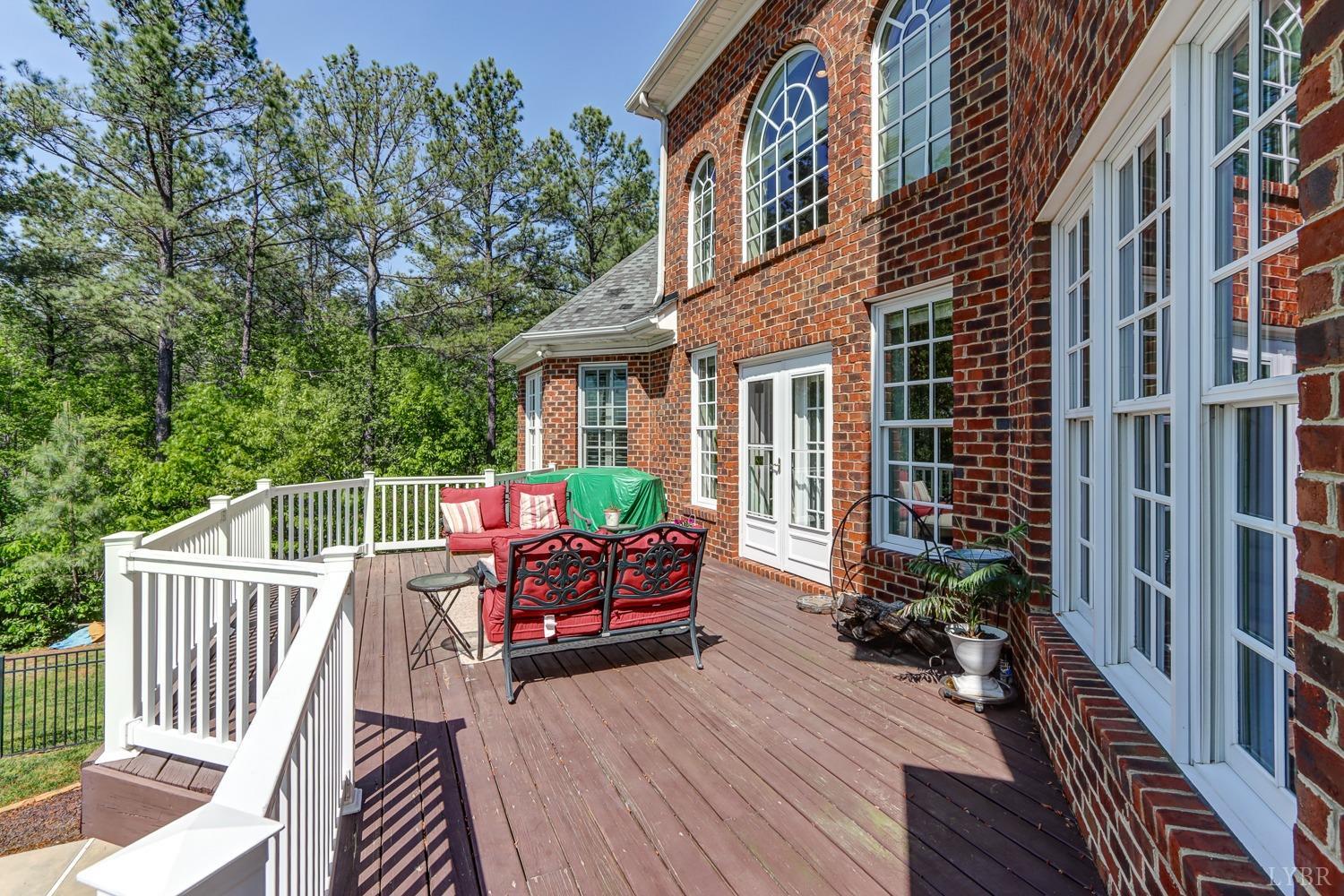 107 Emory Way Amherst, VA 24521 - Photo 33 of 84 a balcony of a house with wooden floor outdoor seating and yard in the back