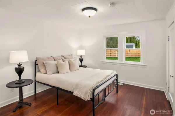 a bedroom with a bed chandelier and window