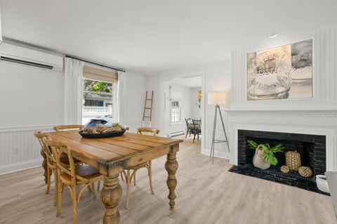 a view of a dining room with furniture and a fireplace