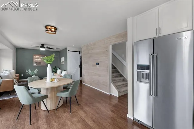 a dining room with furniture and wooden floor