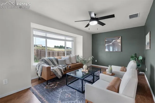 a living room with furniture and a large window