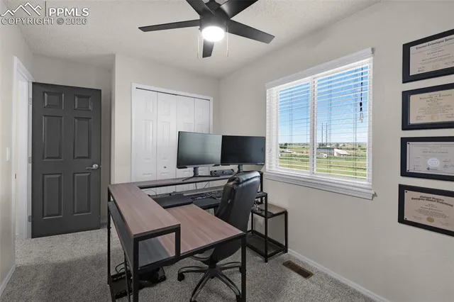 a view of a livingroom with furniture and a window