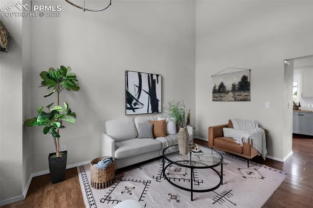 a living room with furniture and a potted plant