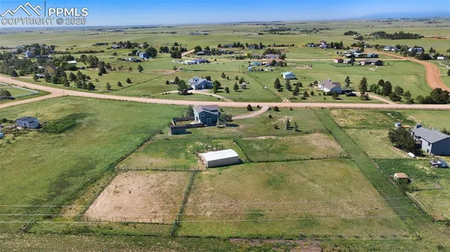 an aerial view of a residential houses with outdoor space