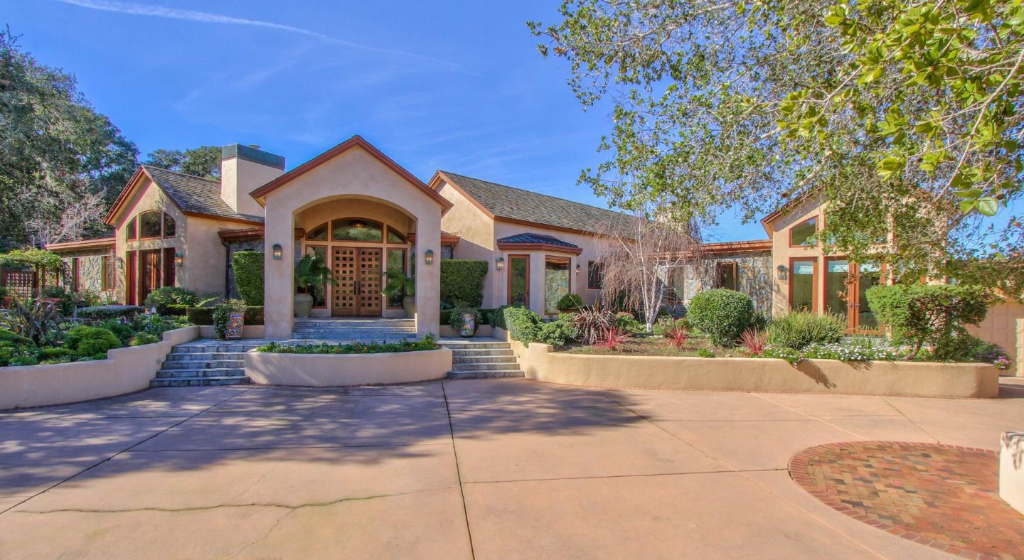 a front view of a house with yard and green space