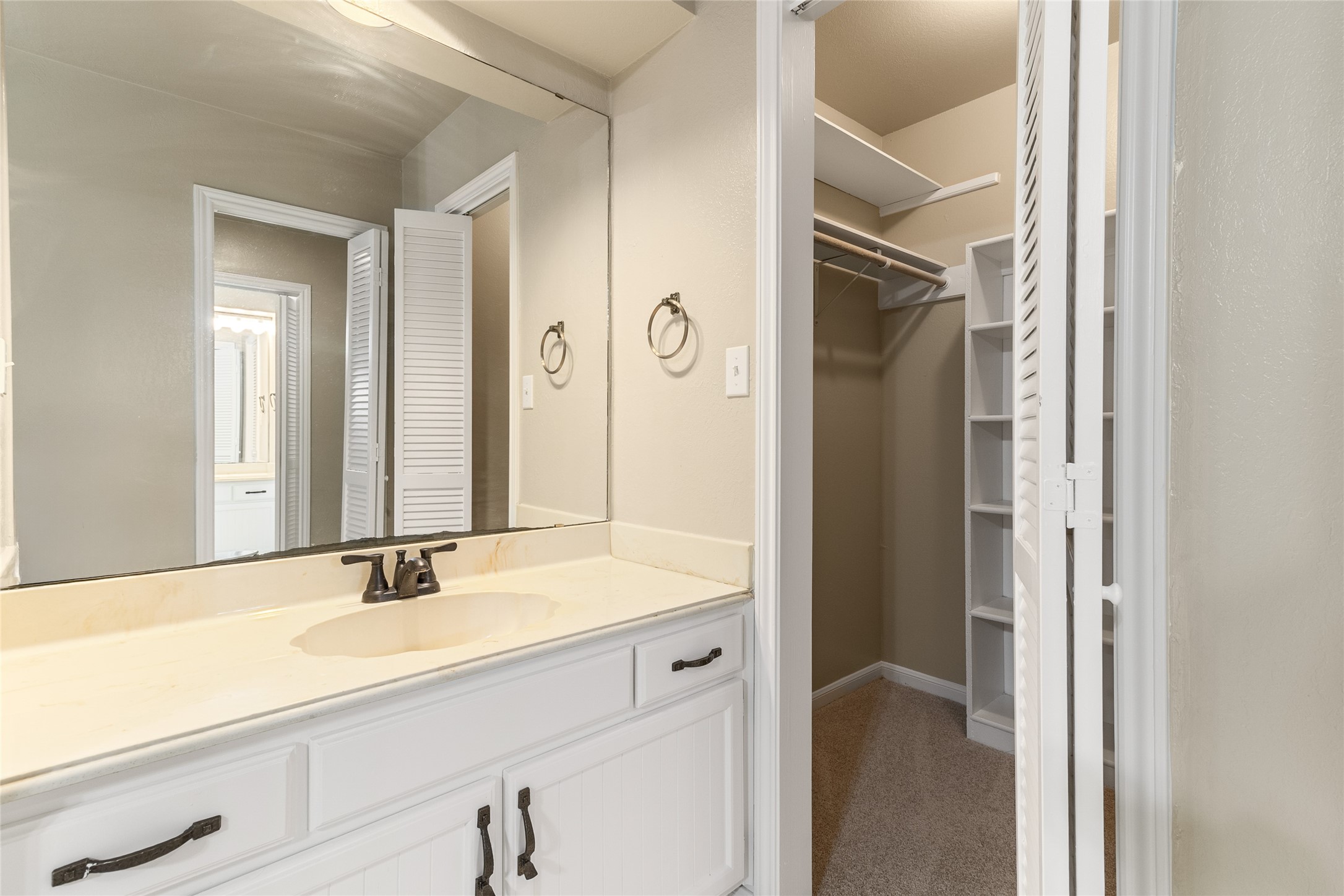 57 South Bachelor Button Street Lake Jackson, TX 77566 - Photo 17 of 29 This thoughtful primary bathroom layout features a single sink on each side of the remodeled shower, offering privacy and flexibility for easy morning routines.