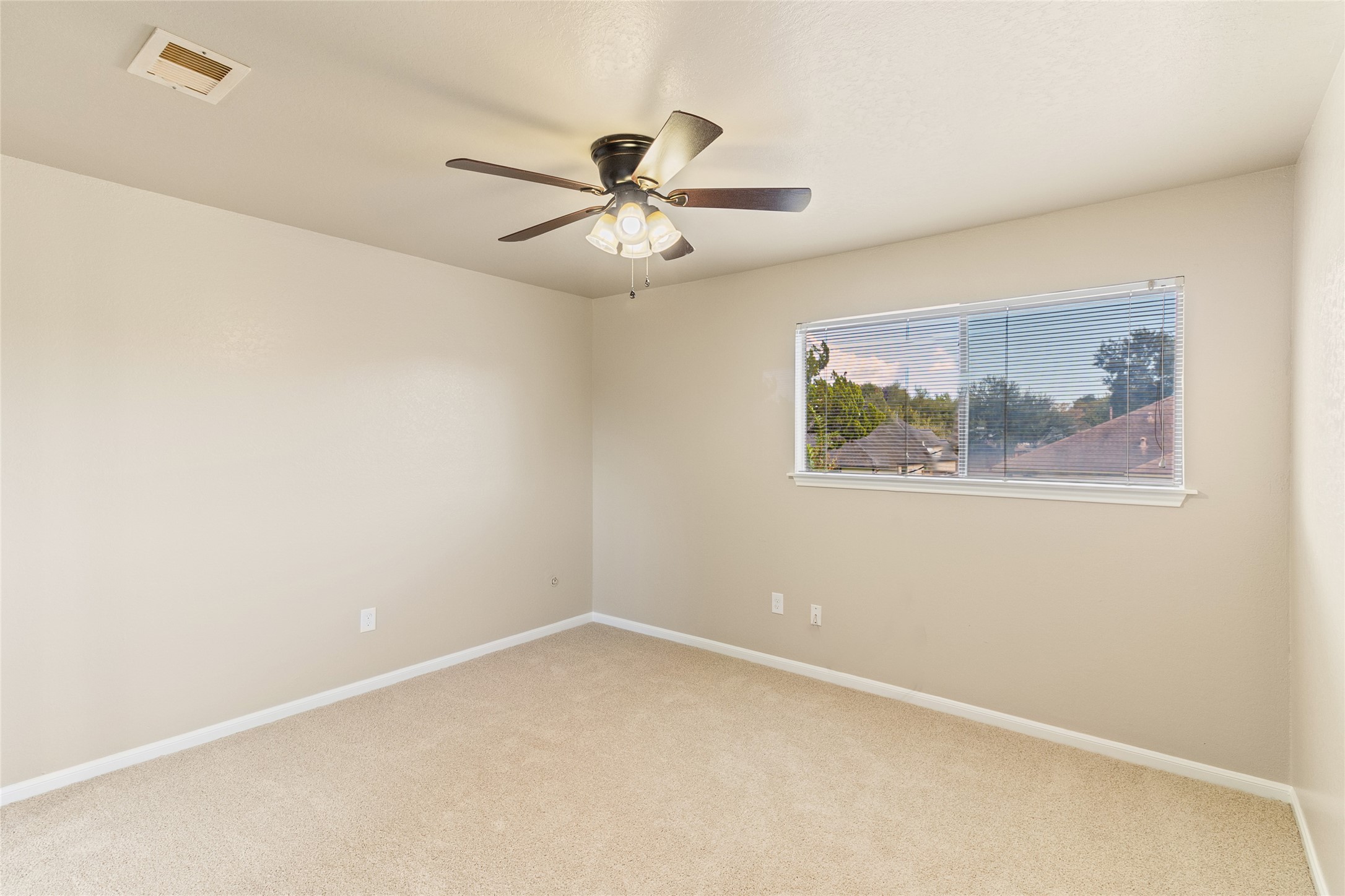 57 South Bachelor Button Street Lake Jackson, TX 77566 - Photo 23 of 29 Bedroom #3 (13x11) features brand-new carpet, fresh paint, and plenty of natural light—offering a bright and comfortable retreat.