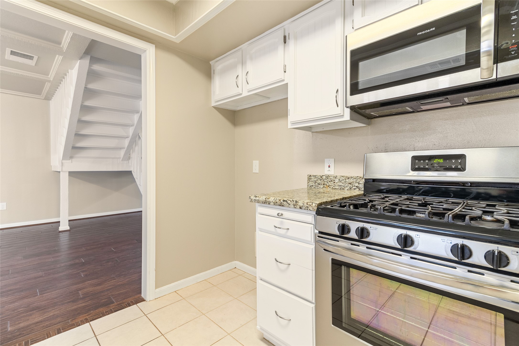 57 South Bachelor Button Street Lake Jackson, TX 77566 - Photo 8 of 29 Equipped with stainless steel appliances, this kitchen offers a seamless connection to the main downstairs living area—perfect for staying connected while cooking or entertaining.