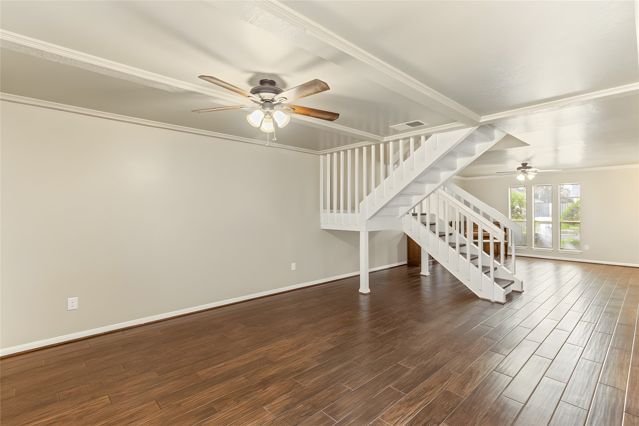 57 South Bachelor Button Street Lake Jackson, TX 77566 - Photo 9 of 29 Looking back toward the front entry, this view showcases the updated light fixtures and modernized staircase—once an open 80’s style, now enclosed for a clean, contemporary look.