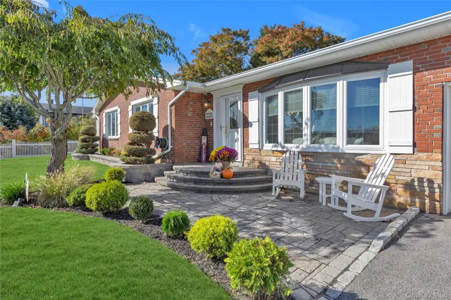 a view of a house with backyard sitting area and garden