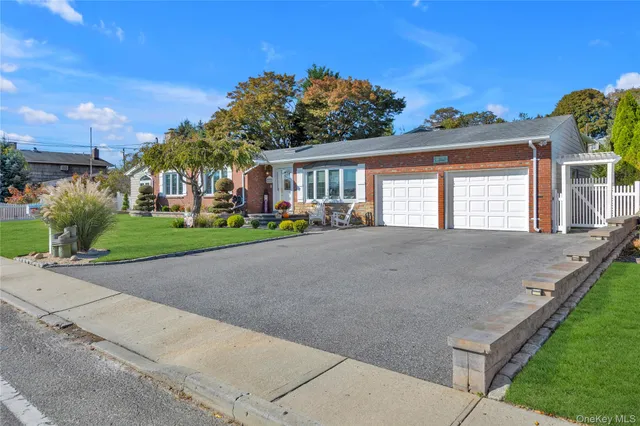 a front view of a house with a yard and outdoor seating