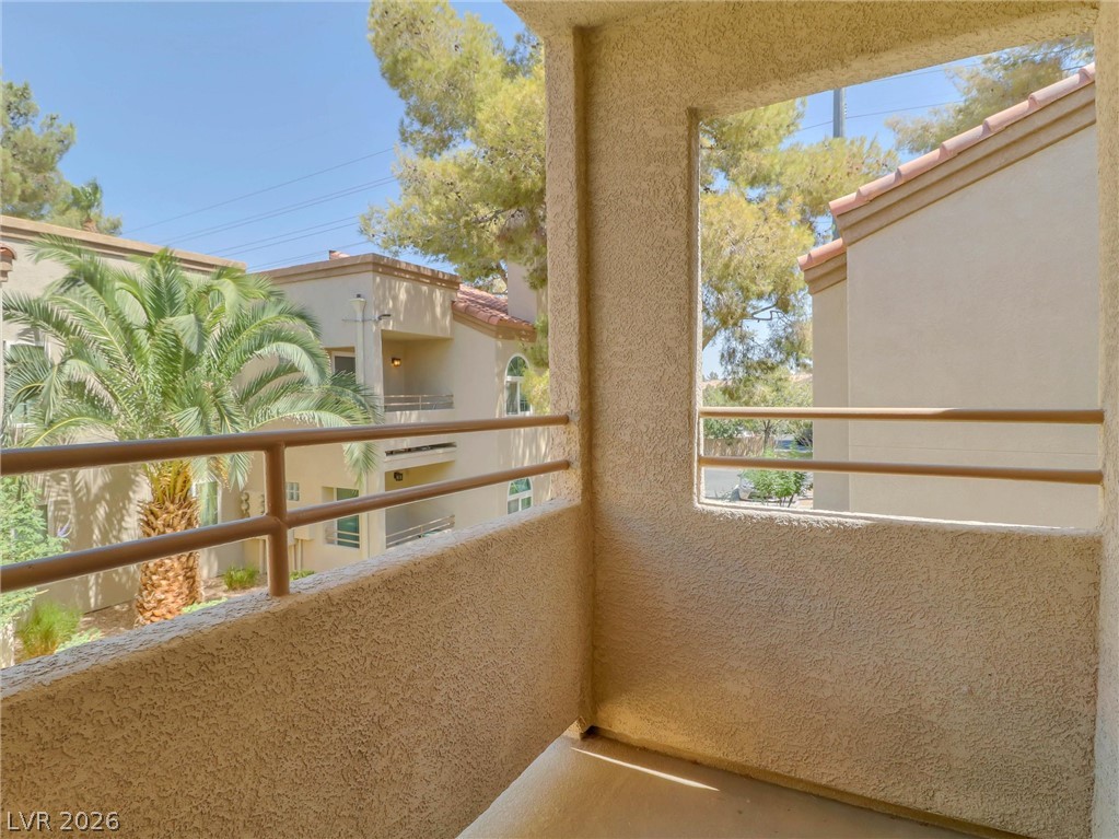 3145 East Flamingo Road, Unit 2129 Las Vegas, NV 89121 - Photo 28 of 43 A private balcony offers serene views of mature palm trees and the surrounding neighborhood.
