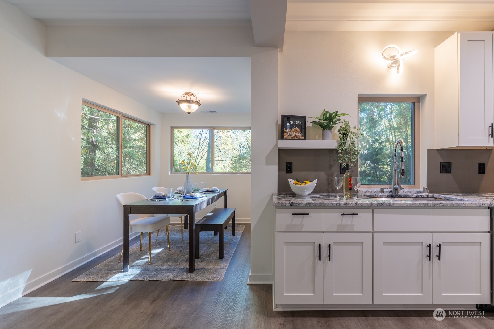 4901 Cleveland Street Port Townsend, WA 98368 - Photo 15 of 39 a kitchen with a sink cabinets and dining table chair