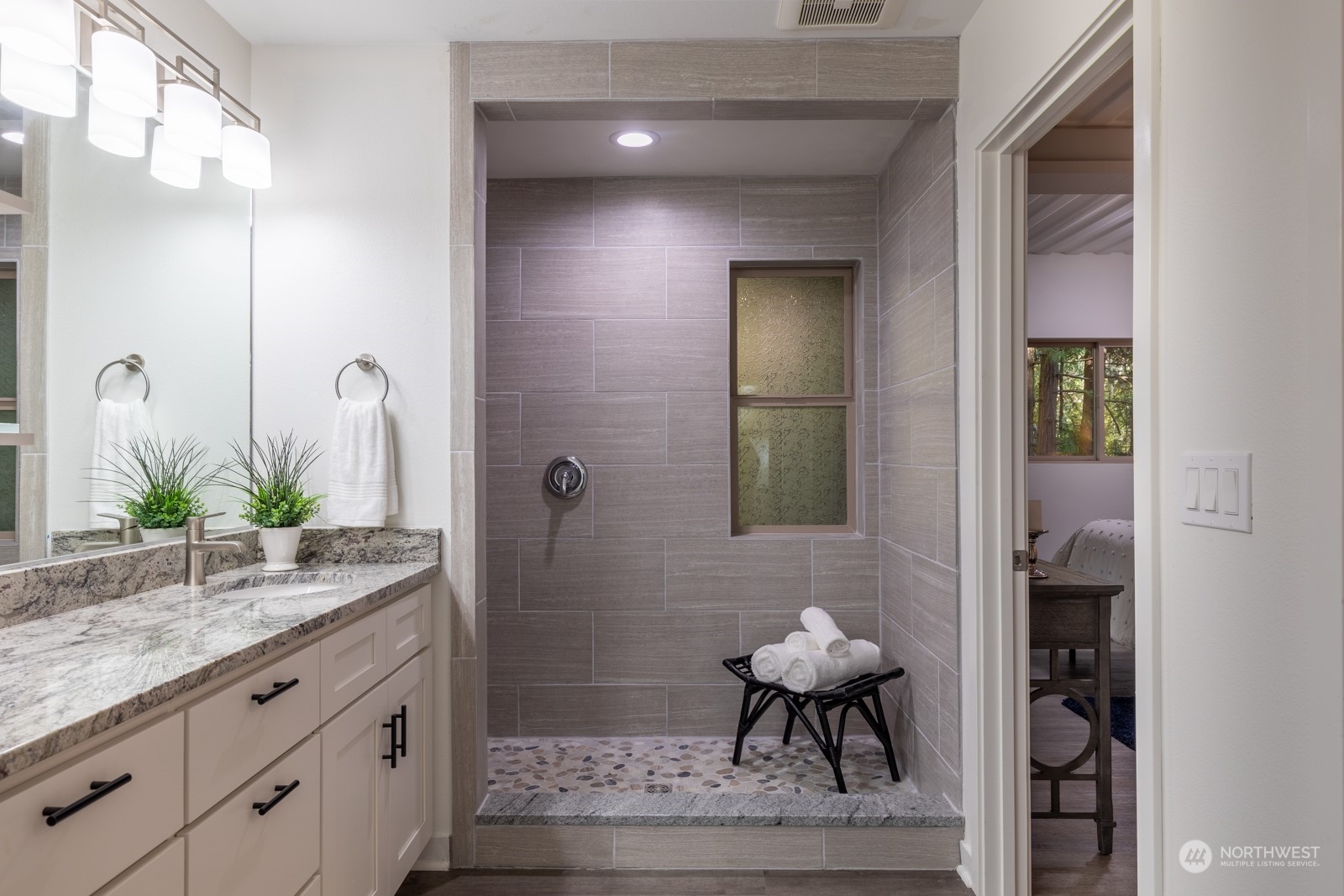 4901 Cleveland Street Port Townsend, WA 98368 - Photo 28 of 39 a bathroom with a sink a light fixture and a glass door shower