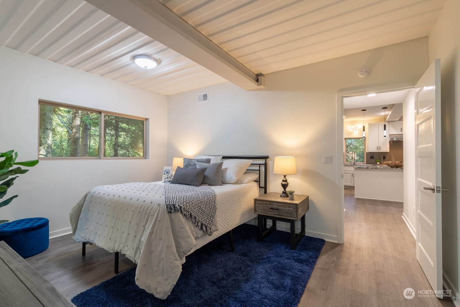4901 Cleveland Street Port Townsend, WA 98368 - Photo 30 of 39 a bedroom with a bed and a large window