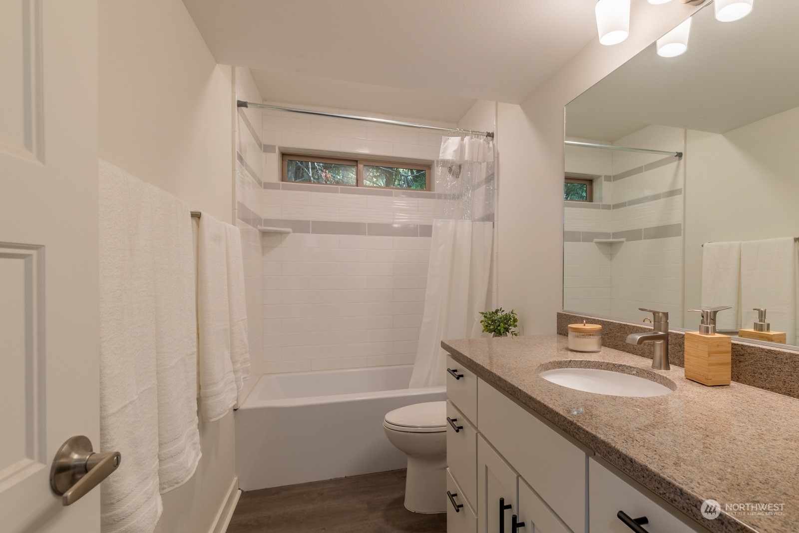 4901 Cleveland Street Port Townsend, WA 98368 - Photo 31 of 39 a bathroom with a granite countertop sink toilet and shower