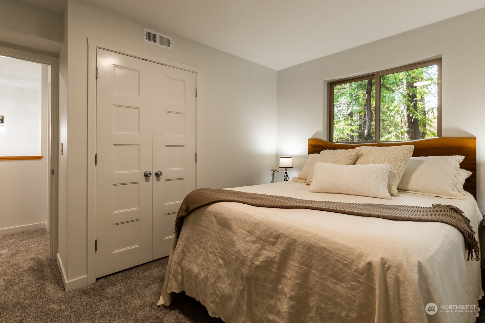 4901 Cleveland Street Port Townsend, WA 98368 - Photo 37 of 39 a bedroom with a bed and a window