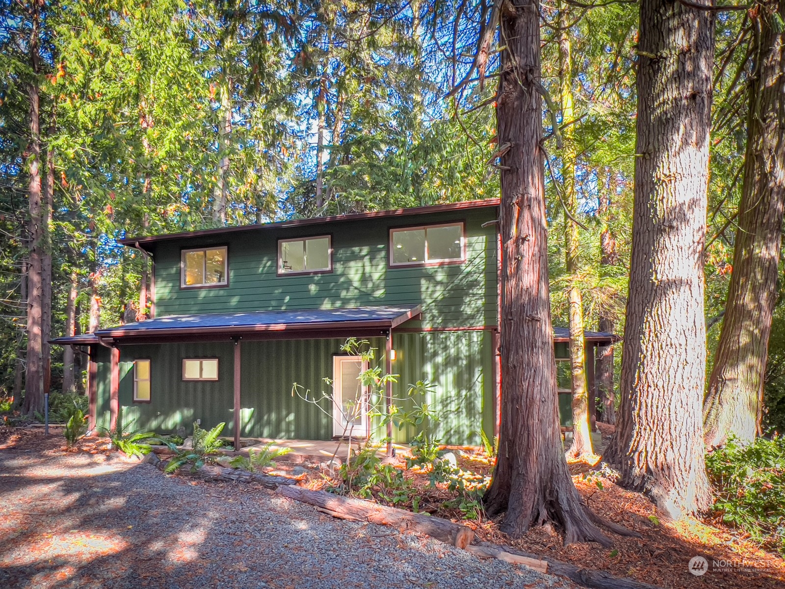 4901 Cleveland Street Port Townsend, WA 98368 - Photo 5 of 39 a front view of a house with a tree