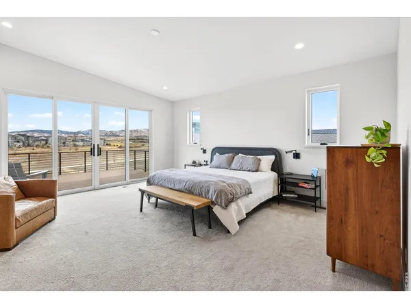 a bedroom with a bed couch and a window