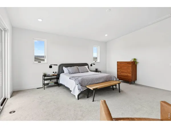 a bedroom with a bed and chair