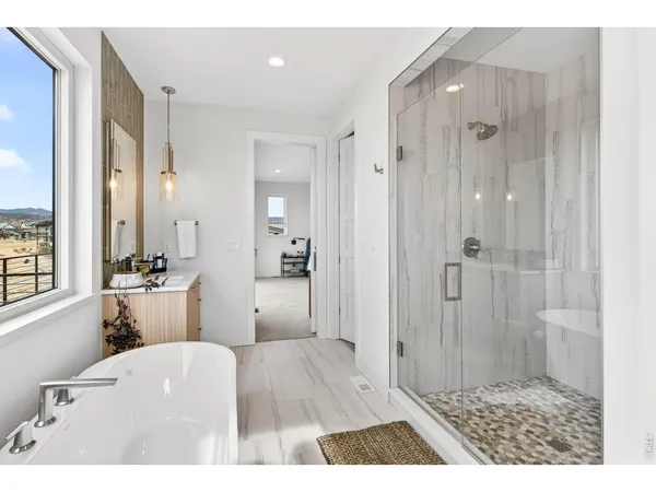 a bathroom with a sink a toilet a shower and a mirror