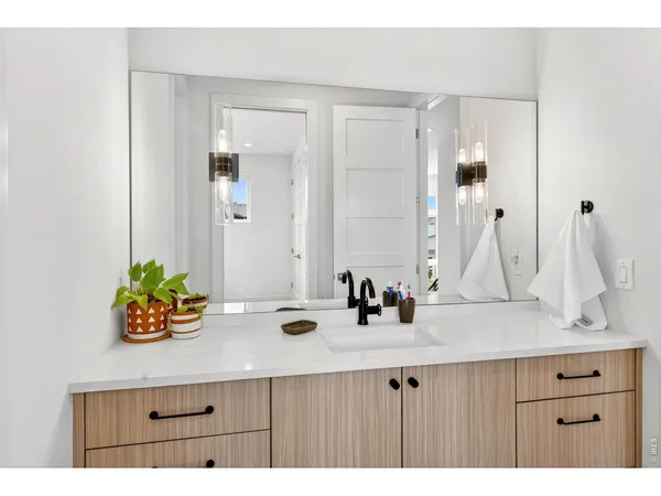 a bathroom with a sink double vanity and a mirror
