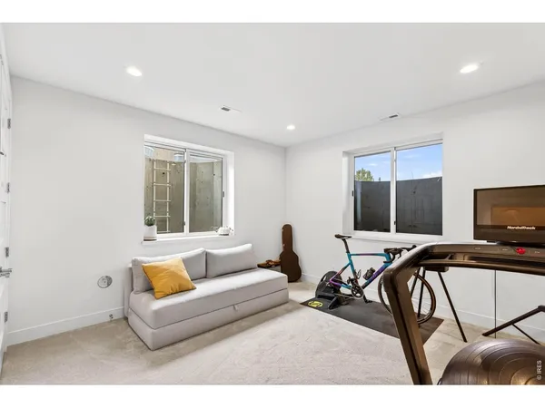 a view of a livingroom with furniture and a flat screen tv