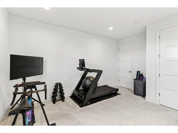 a room with gym equipment and a flat screen tv