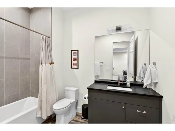 a bathroom with a sink toilet a mirror and shower