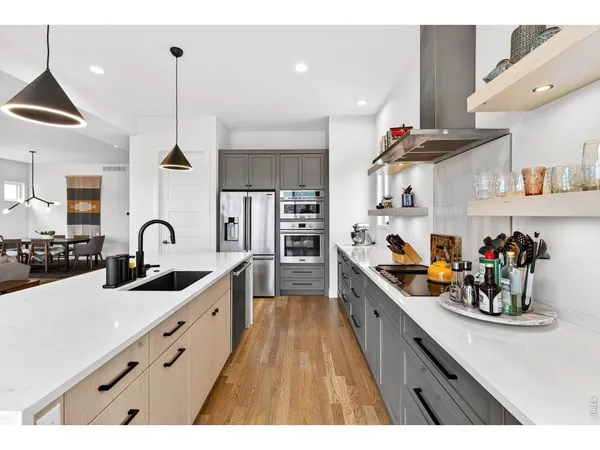 a kitchen with sink a stove and cabinets