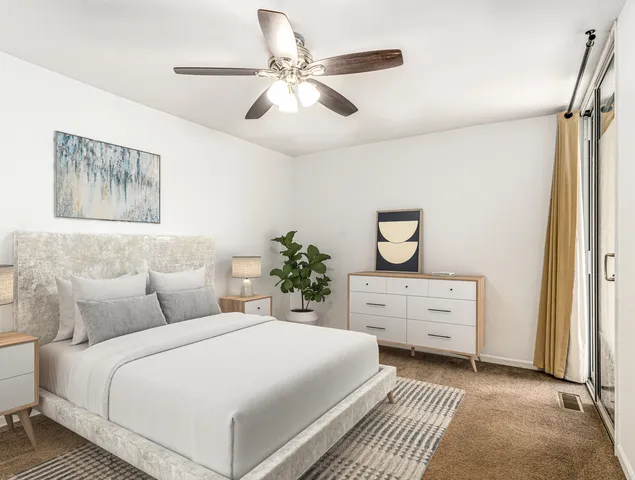 a bedroom with a bed and a dresser