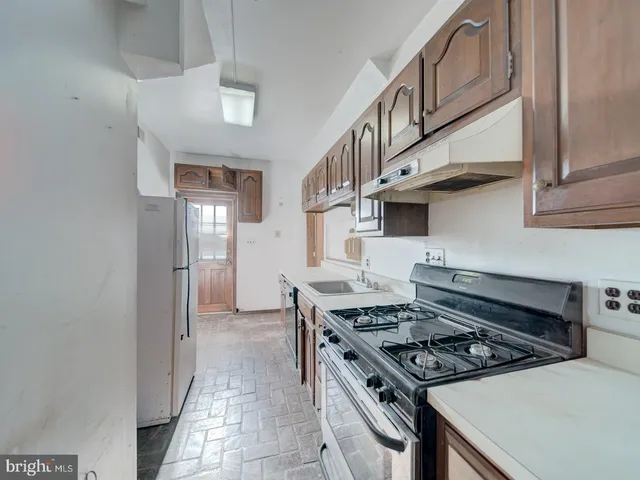 a kitchen with granite countertop a stove and a sink
