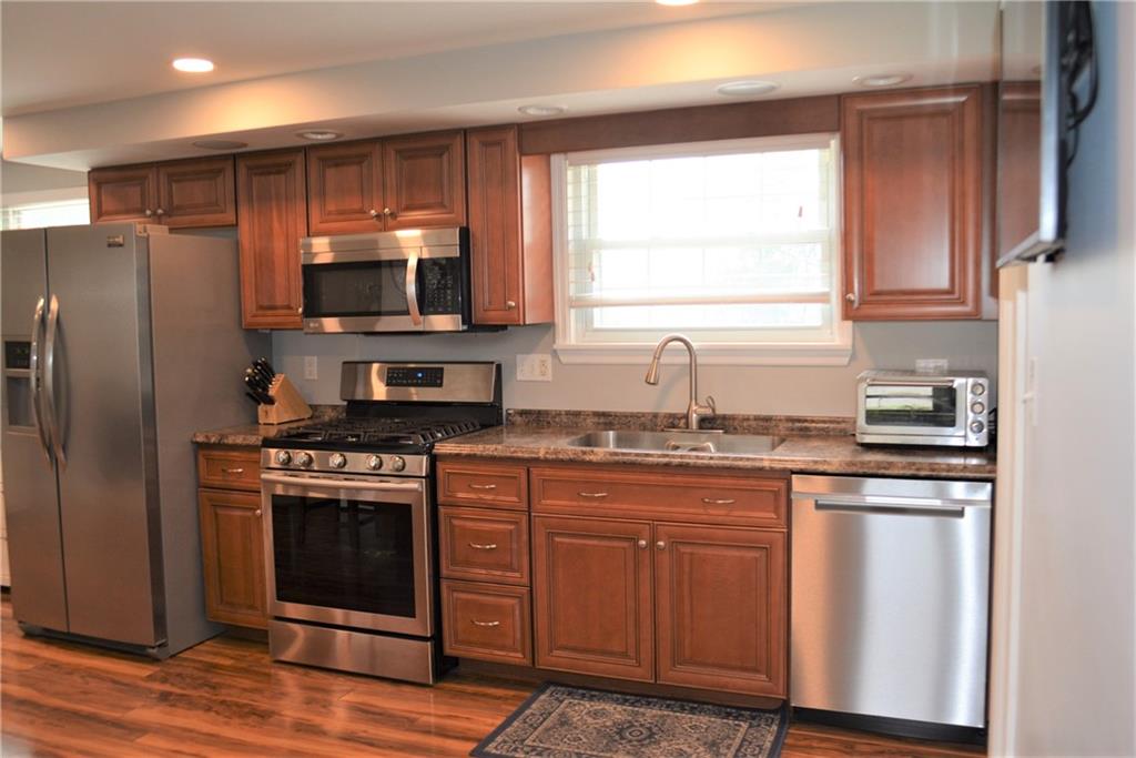 3035 Pitchfork Drive McKees Rocks, PA 15136 - Photo 8 of 21 a kitchen with stainless steel appliances granite countertop a stove a sink dishwasher a refrigerator and a microwave oven