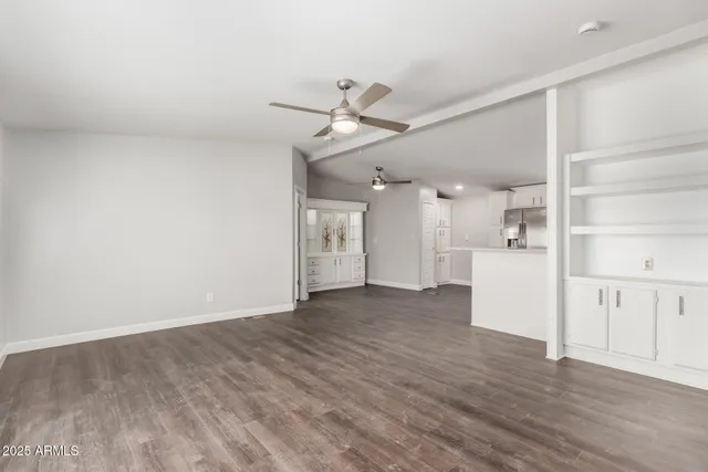a view of a kitchen with a refrigerator and a stove top oven