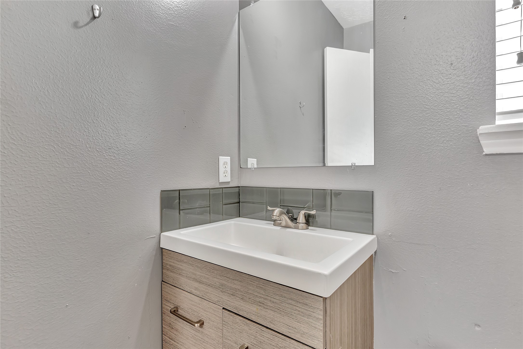 1007 Addison Park Lane Spring, TX 77373 - Photo 12 of 24 This stylish half bath features a sleek vanity, contemporary fixtures, and a modern color palette, offering both functionality and a touch of elegance.