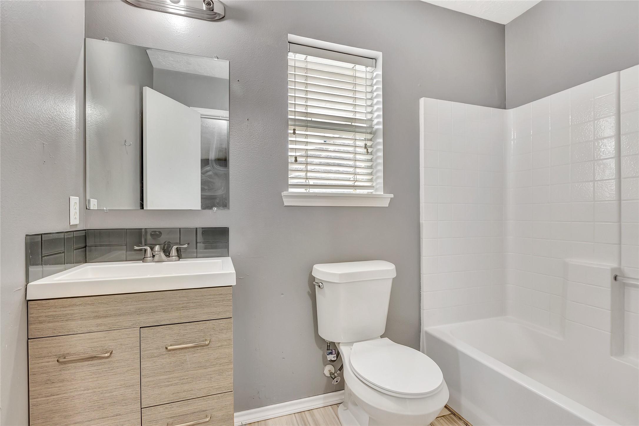 1007 Addison Park Lane Spring, TX 77373 - Photo 13 of 24 This inviting upstairs bath features modern fixtures, a sleek vanity with ample storage, and a bright, airy ambiance perfect for relaxation.