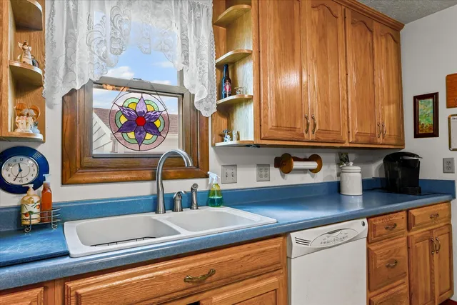 a kitchen with stainless steel appliances granite countertop a sink and a microwave