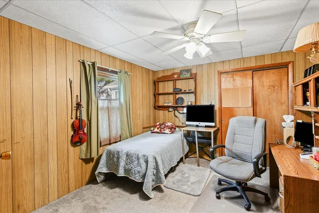 a bedroom with a bed and a chair