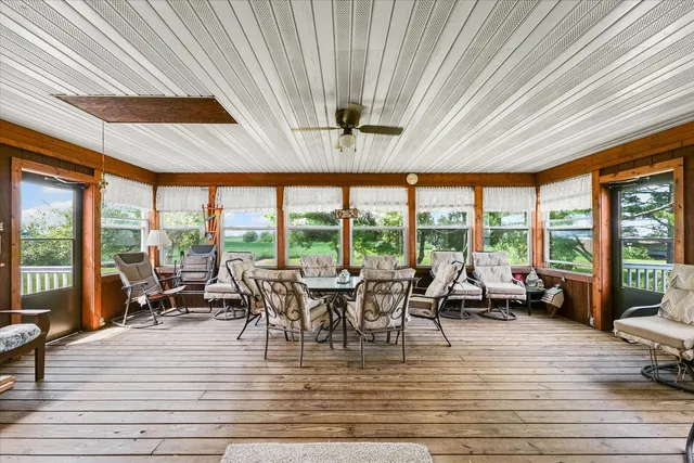 a living room with furniture and floor to ceiling windows