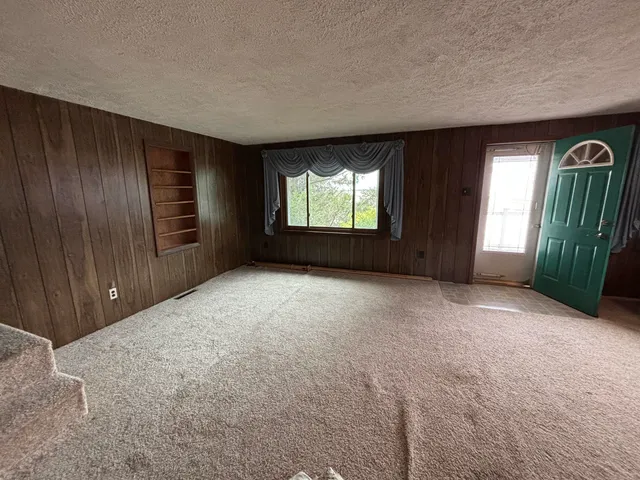 an empty room with windows and entrance