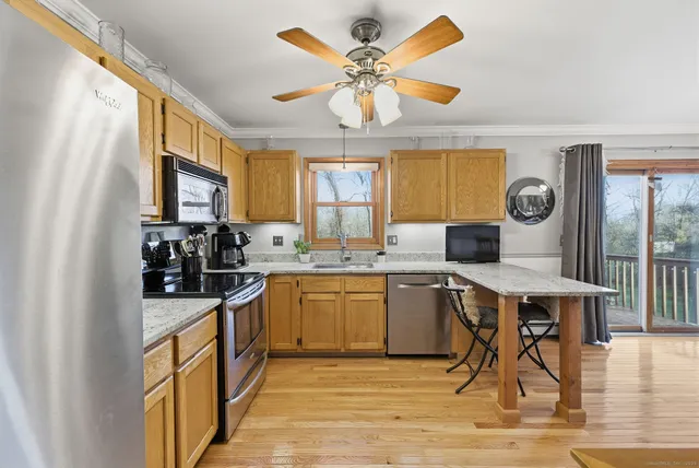 a kitchen with a stove a sink a dining table and chairs