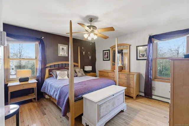 a bedroom with a bed dresser and a window